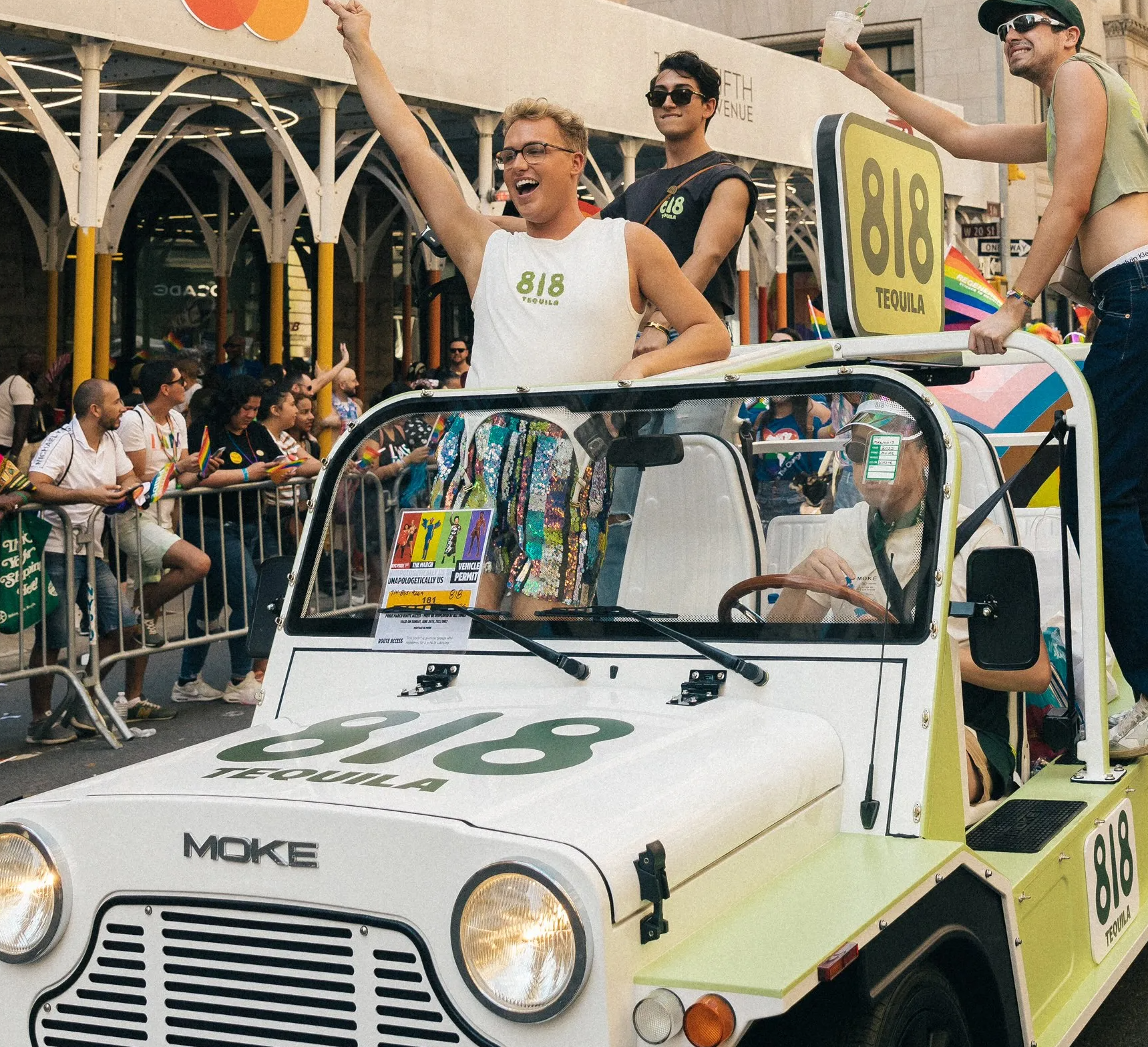 Guests celebrating NYC Pride inside of an 818-branded Moke vehicle.