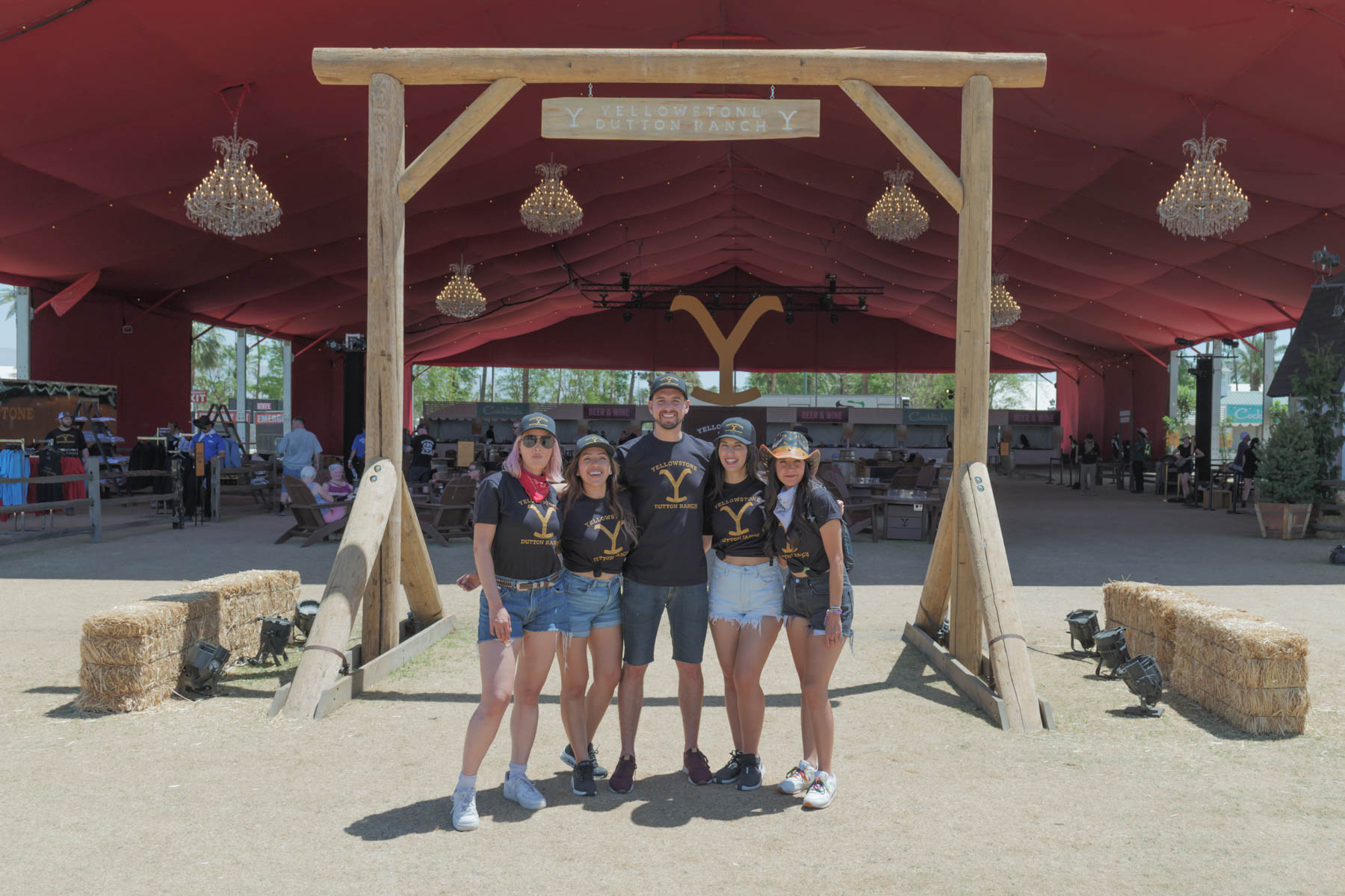 Brand ambassadors posing in front of the Yellowstone Dutton Ranch sign at the entrance of the activation.