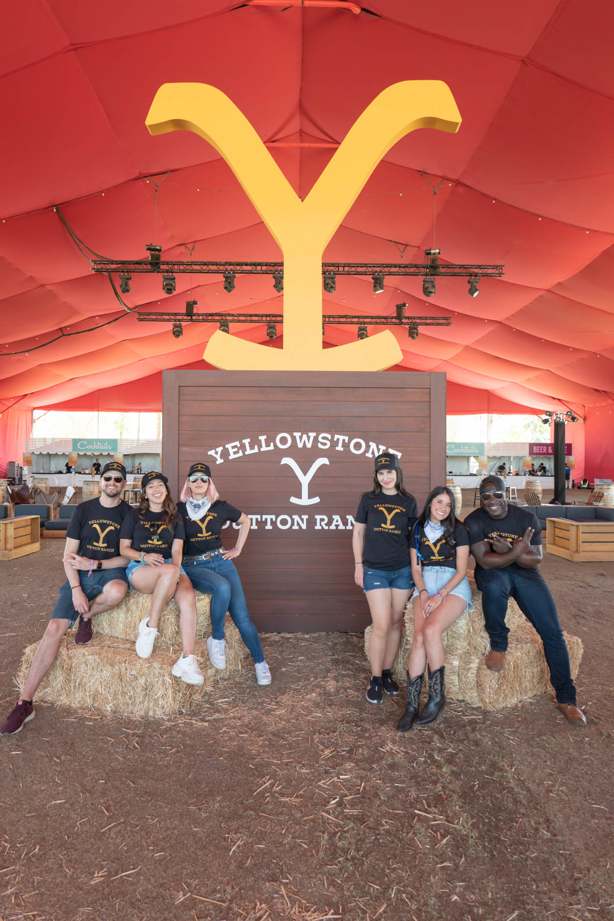 Brand ambassadors posing in front of a giant Yellowstone Y logo.