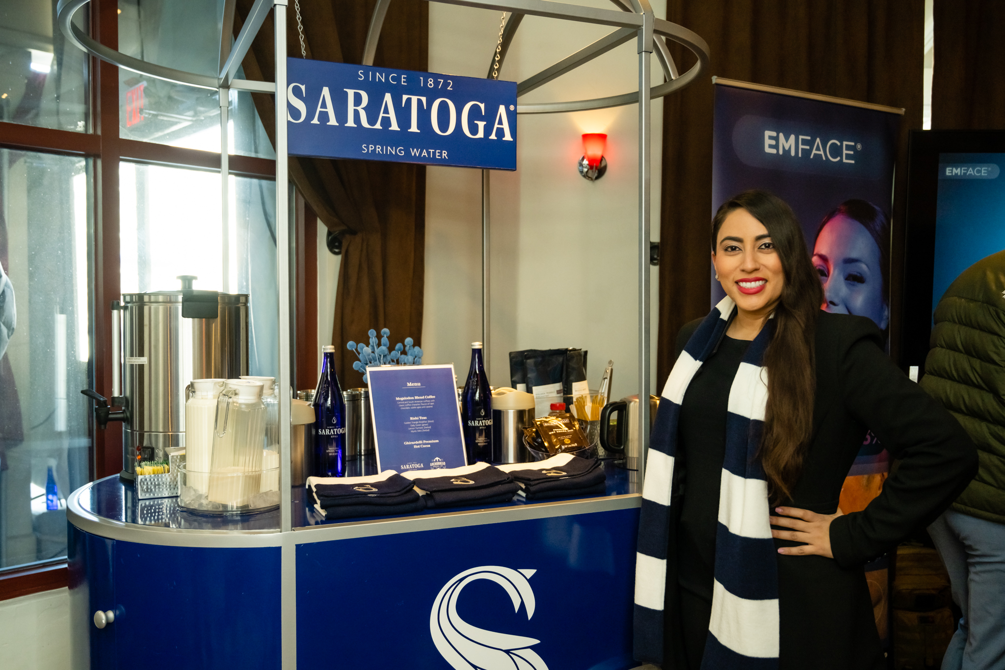 A brand ambassador in front of a Saratoga Spring Water drink cart.