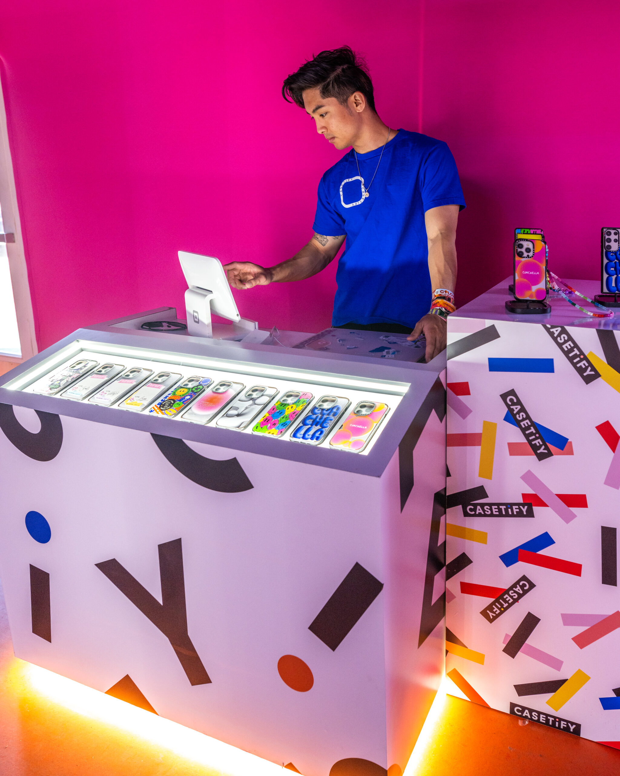 A staff member on the register at the custom-made counter.