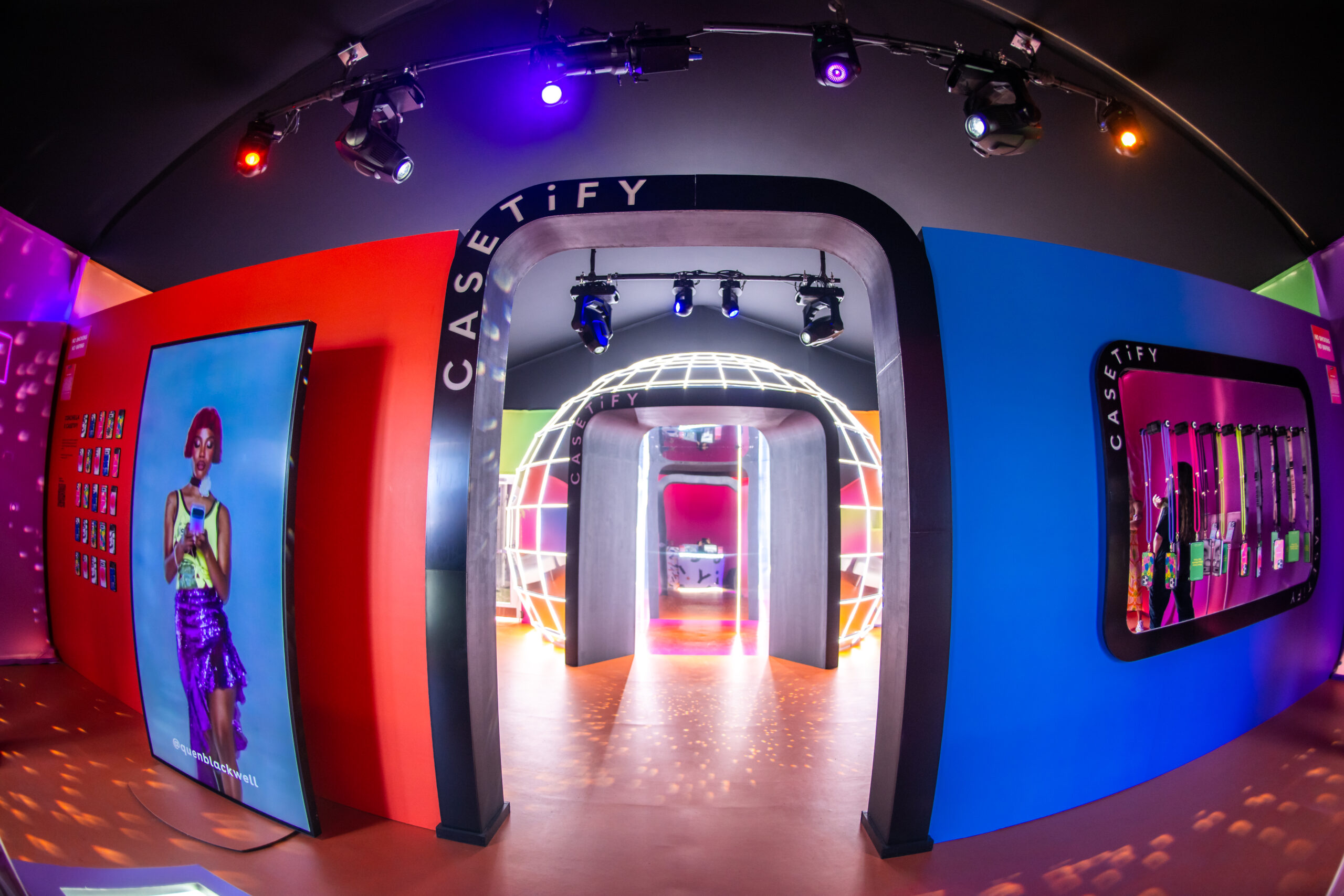 A phone case shaped archway that leads to the entrance to the CASETiFY disco lounge.