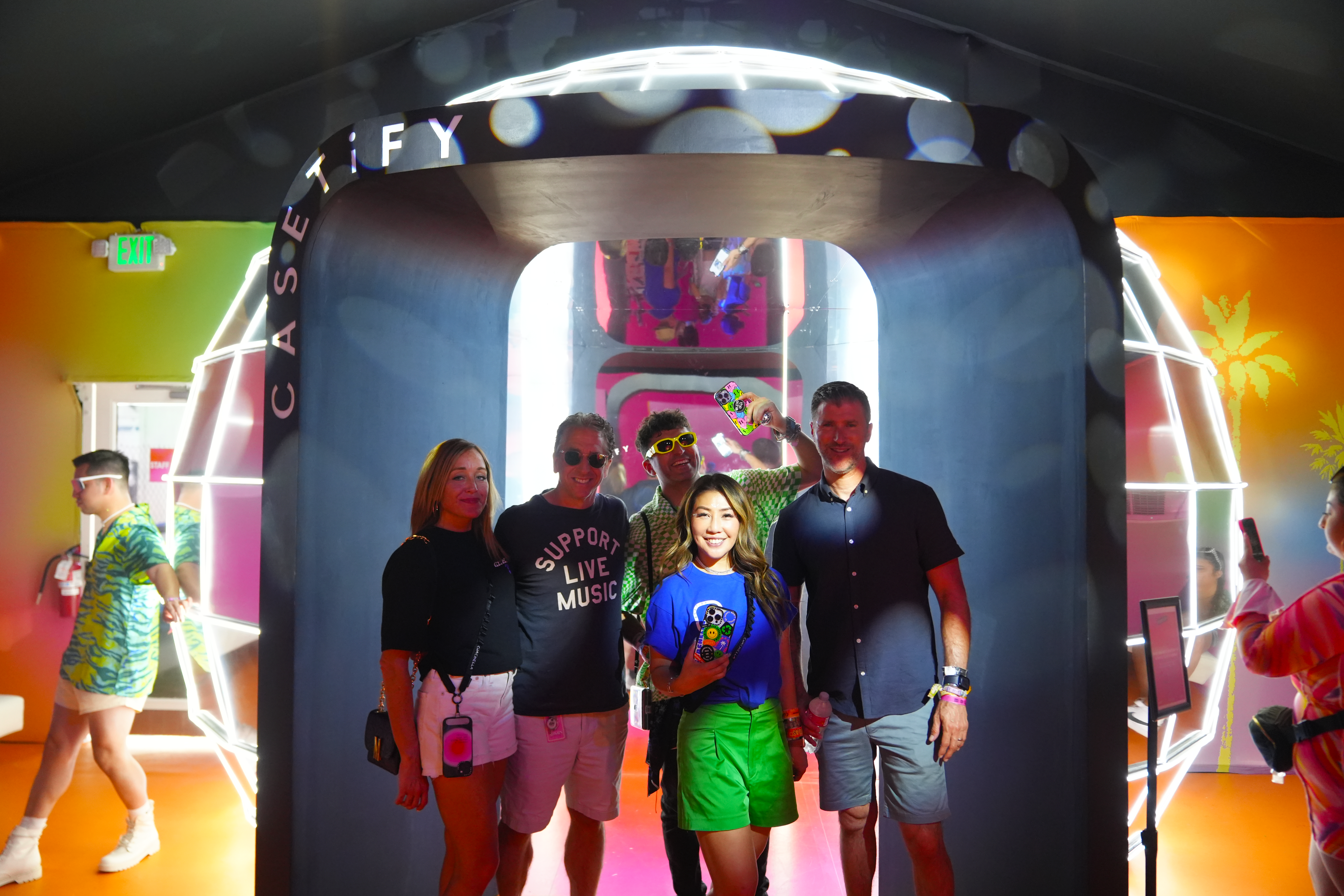 Friends posing in front of the giant disco ball.