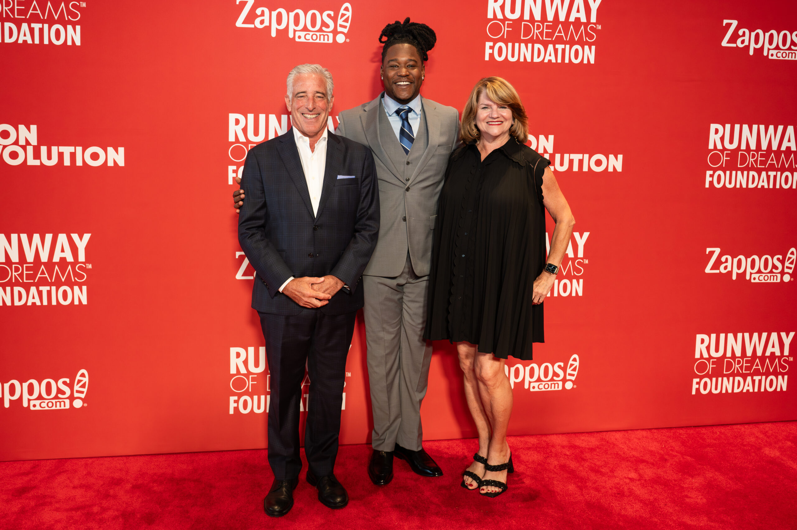 Gary Sheinbaum, Shaquem Griffin, and Dawn Robertson posing on the red carpet.