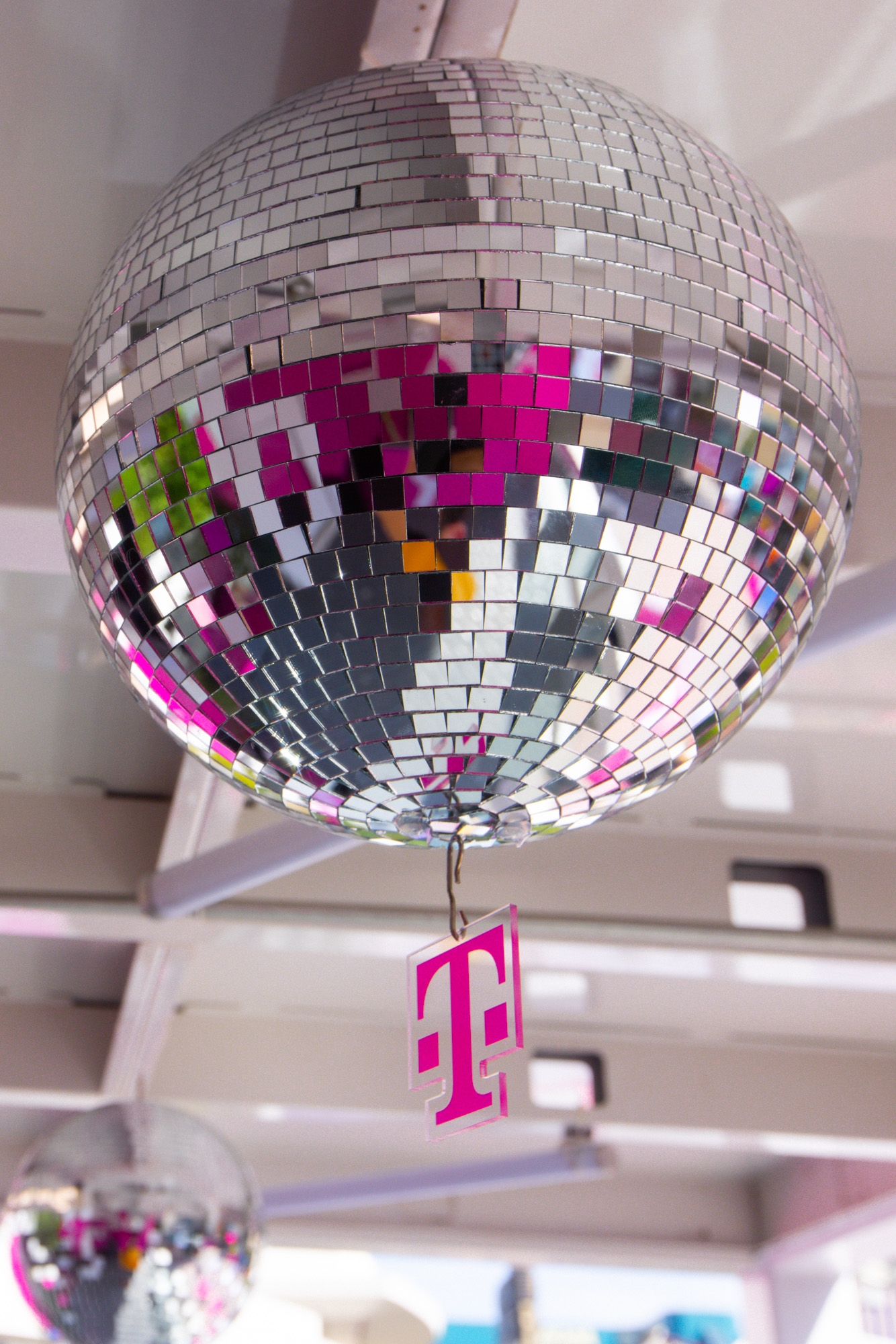 A close-up of a disco ball with the T-Digit logo underneath