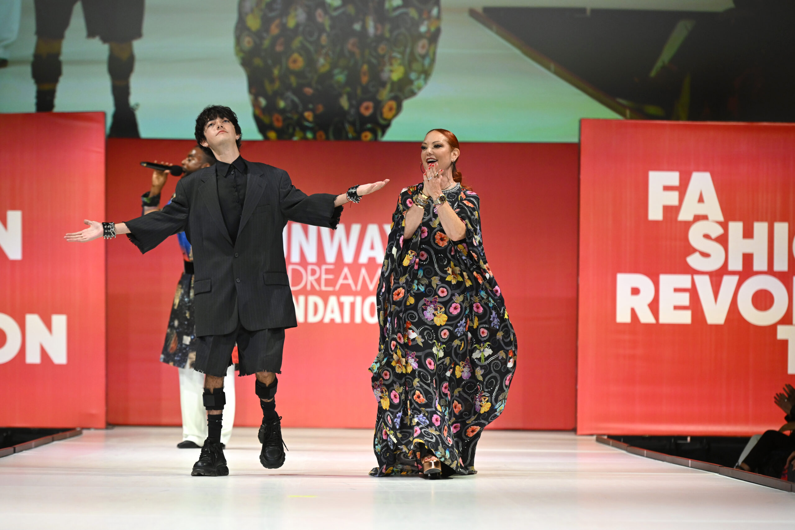 Oliver Scheier and Mindy Scheier greeting the audience from the runway.