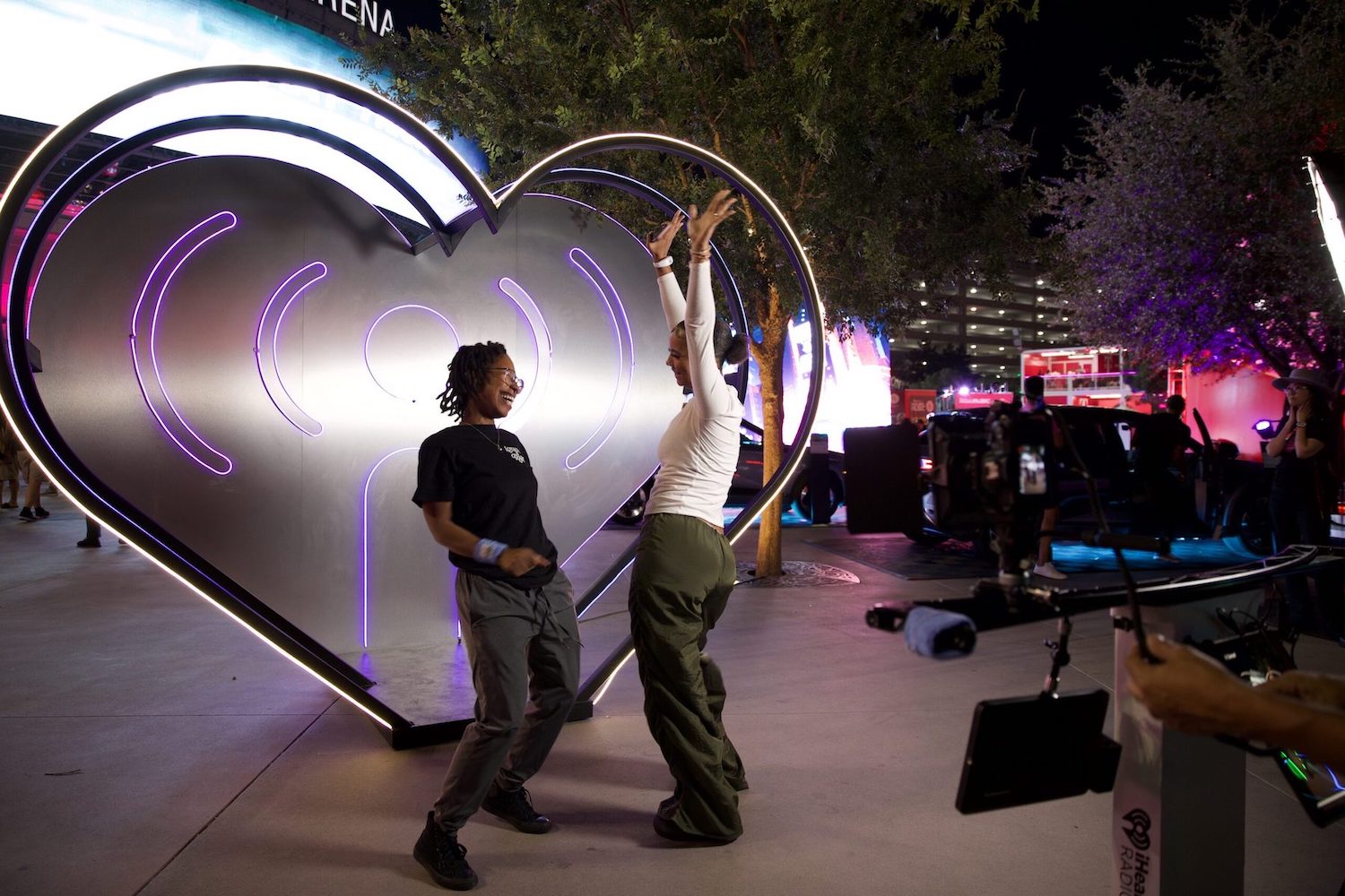 Two friends having fun in front of the Electric Heart.