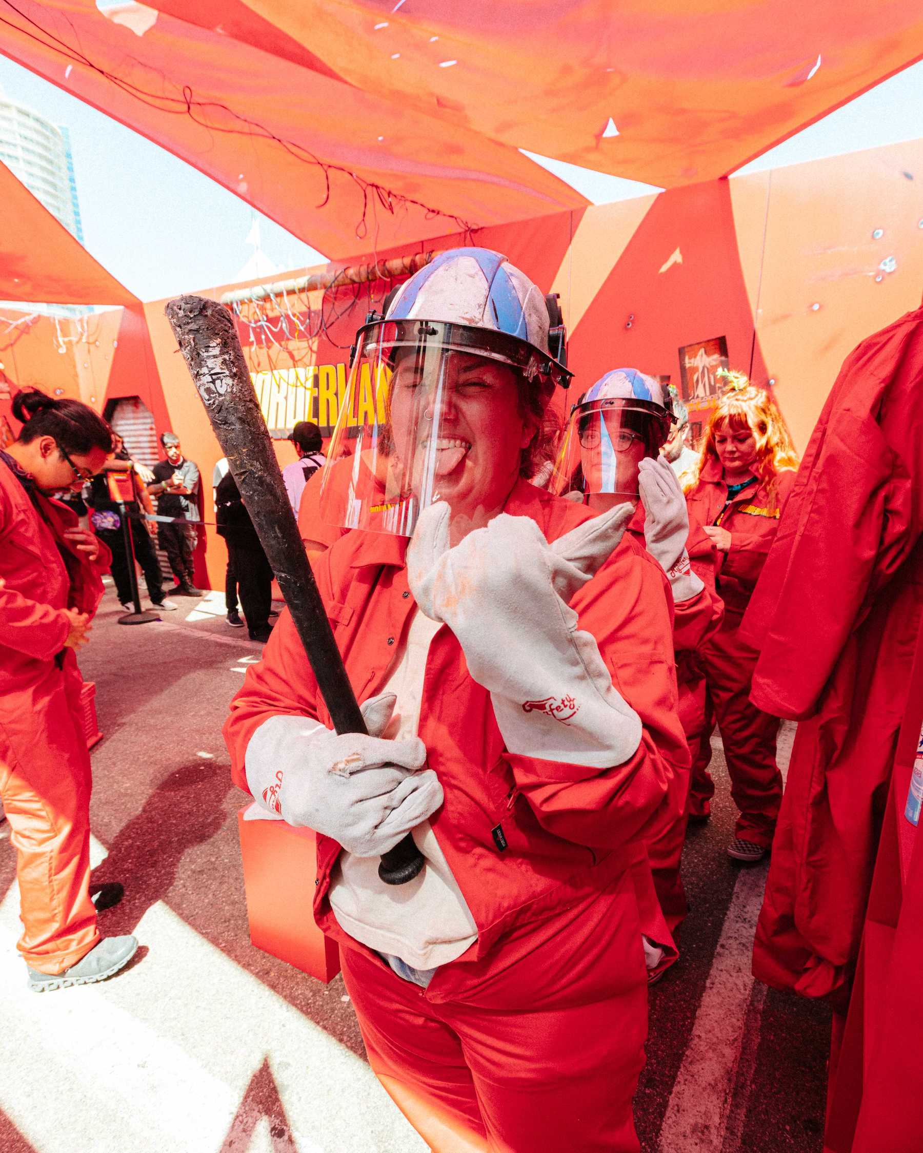 woman with protective gear and bat going into borderlands rage room